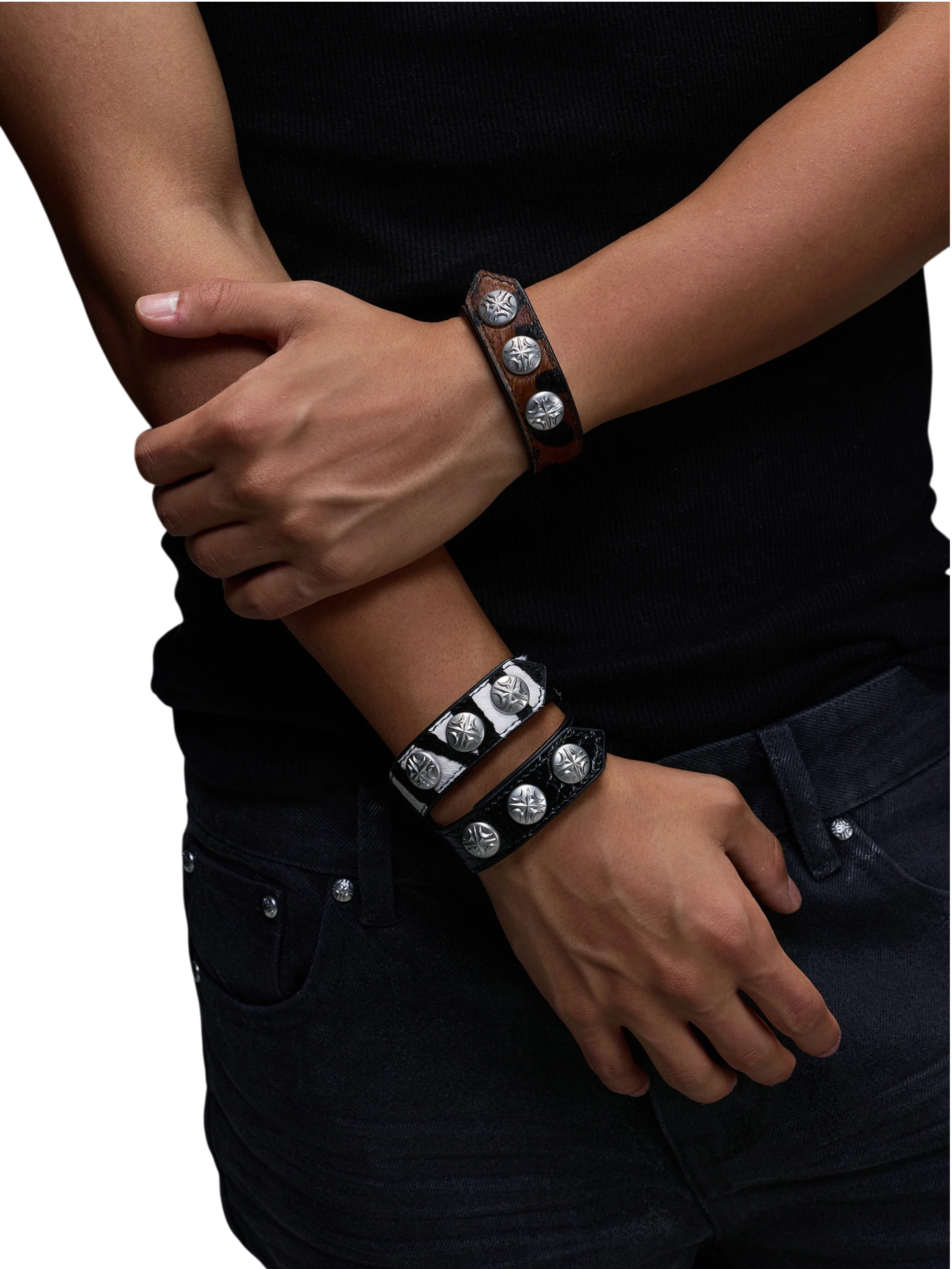 Model wearing a TBHNP leather bracelet, wrist detail.